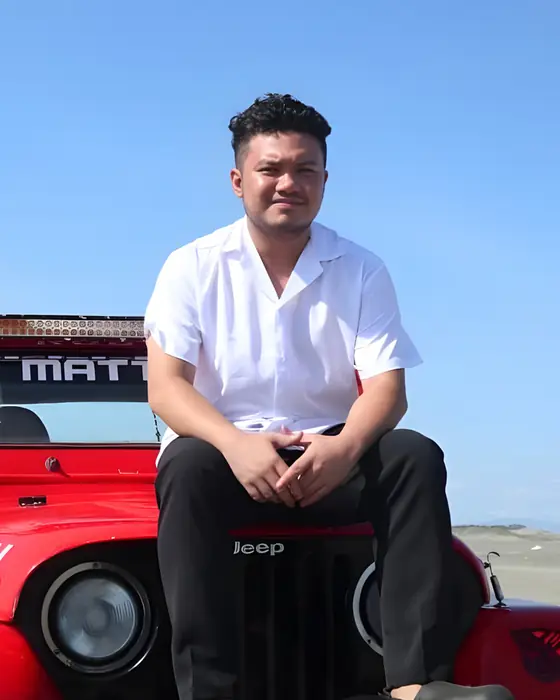 A Unicorn sitting on a red jeep at the beach
