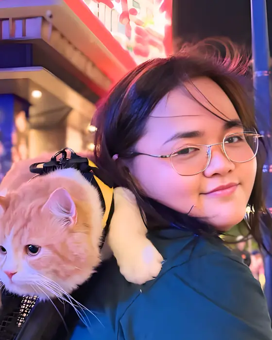 A Unicorn out at night with her orange cat in a backpack